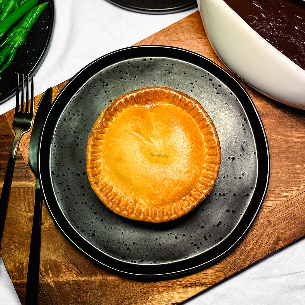 Meat and potato pie with golden crust