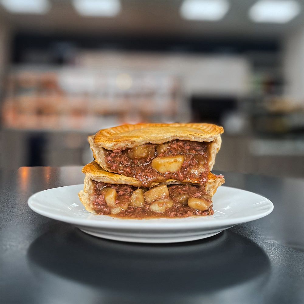 A traditional, British Meat and potato pie cut open, ready to serve. Made with British mince meat and English potatoes.